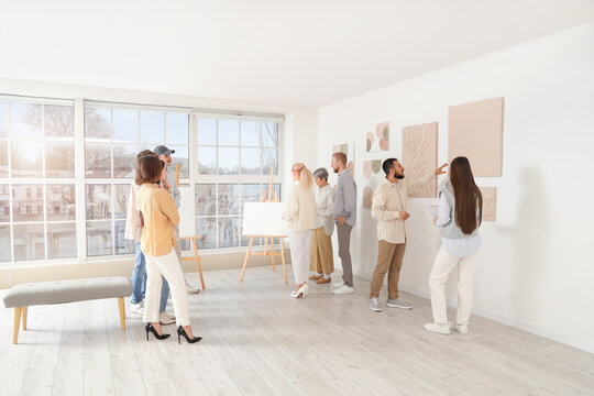 Group of people at exhibition in art gallery