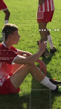 Vertical video: Soccer teen lifting bottle and hydrating, settling as white-dot overlays appearing