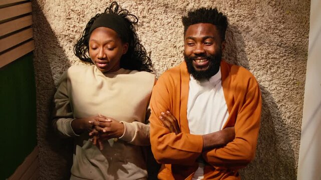 Top down view, black couple, laughing at home, hallway floor, cozy moment, laughter and romance under soft light. Man and woman bonding and spending quality time, positive relationship.