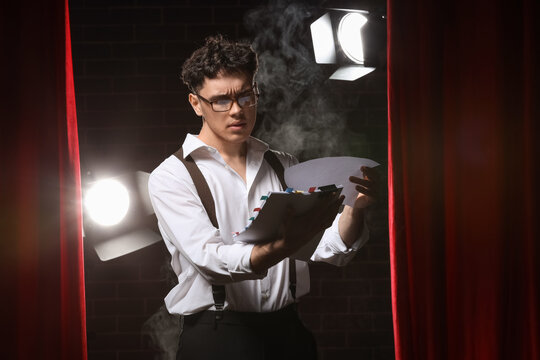 Male screenwriter reading scenario on scene