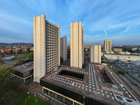 Aerial view of the modern BolognaFiere towers and exhibition district under a clear blue sky in Bologna, Emilia-Romagna, Italy.