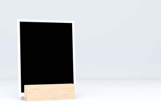 Three blank instant photo frames on wooden hemisphere stands, minimalist mockup template on transparent background