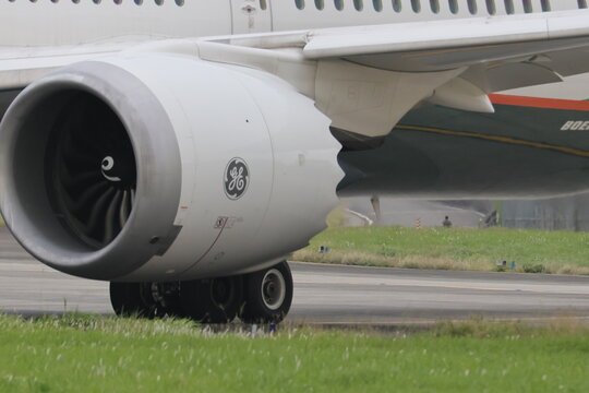 Close up of a Boeing 787 jet engine on the runway.