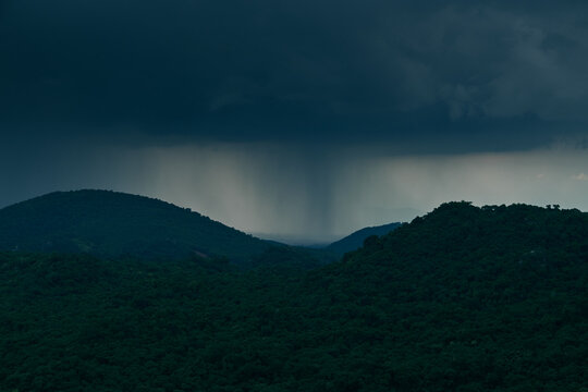 green mountain valley under moody cloudy sky