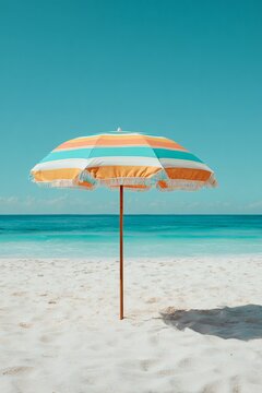 Yellow beach umbrellas and chairs stand on the tropical sand by the sea under a sunny blue sky, offering a relaxing summer vacation landscape at a coastal resort island