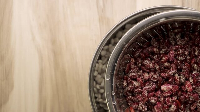Pinto_beans_in_colander_reveal_empty_wooden_table_Copy_Space_4k_10bit