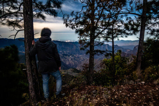 Man standing in front of a night landscape contemplating, forest at night in Mexiquillo Durango 