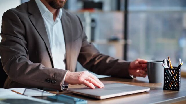 Productive employee prepare work sit down workplace holding coffee cup closeup.