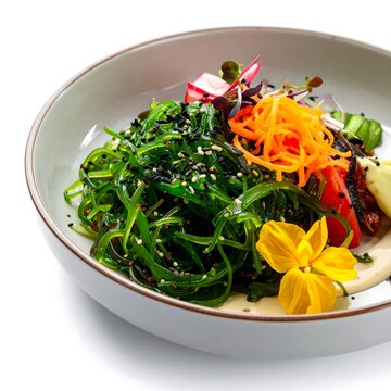 Vibrant seaweed salad bowl with colorful vegetables and garnishes