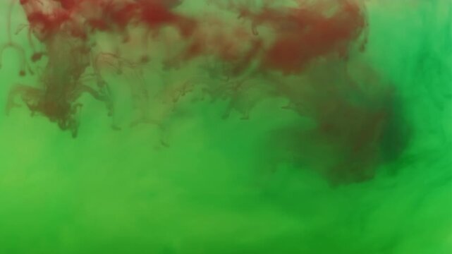 Splash ink. Liquid texture. Defocused green red crimson color acrylic water flowing smog floating on abstract art creative background.