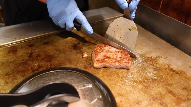 Japanese Chef Slicing Wagyu Beef on Teppanyaki Grill in Osaka