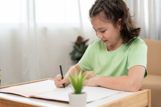 Happy Asia child play and learn drawing picture and cartoon. Funny family is happy and excited in the house. Mother and daughter  having fun spending time together. Holiday, Activity