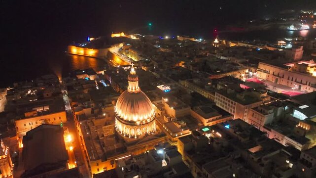Valletta, Malta at Night. Aerial View of Basilica of Our Lady of Mount Carmel Cathedral Dome in Lights