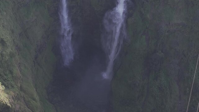 Thrilling zipline experience over Tad Fane twin waterfalls in Bolaven Plateau, Laos - Aerial drone shot ( HLG log )