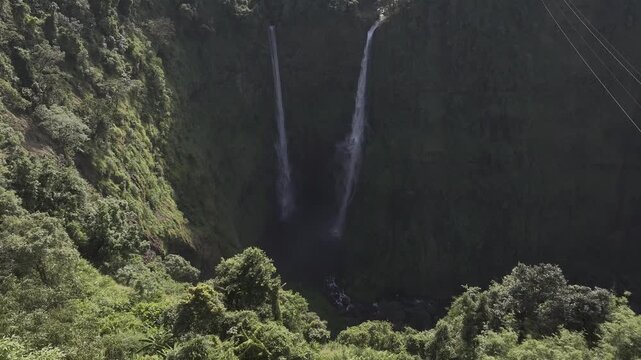 Thrilling zipline experience over Tad Fane twin waterfalls in Bolaven Plateau, Laos - Aerial drone shot ( HLG log )