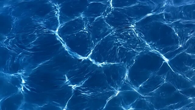 Closeup of Rippling Blue Water Surface with Sunlight Reflections.