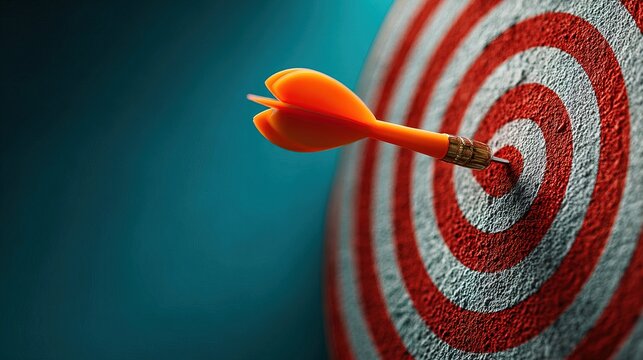 Close Up Textured Orange Dart Hitting Bullseye on Dartboard Representing Business Success Achievement Goal Concept