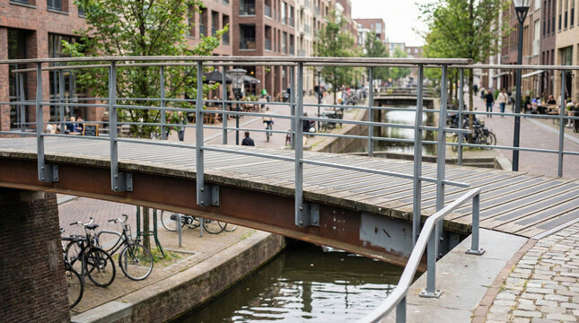 Urban footbridge over narrow canal in residential neighborhood  