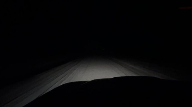Driving at night along rural dirt road