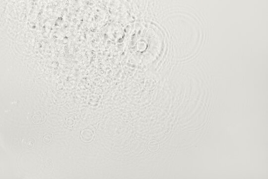 Transparent liquid creating abstract patterns with splashes