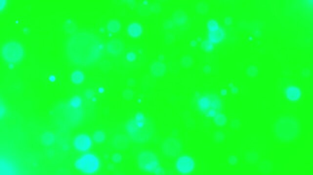 A video showcasing a small yellow object on a vibrant green background with blue spots
