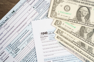 Fototapeta premium Tax form 1040 U.S. Individual Income Tax Return with dollar banknotes money.