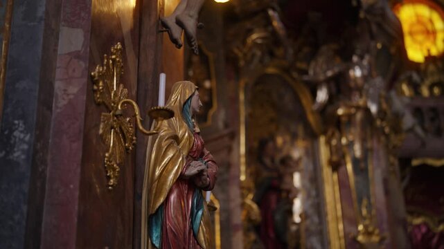 Religious statues and gilded architectural details of the historic Asam Church, Munich sightseeing.