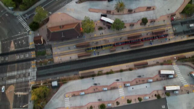 Drone flying east at 6AM with camera facing down and tilting up toward the rising sun over San Diego.