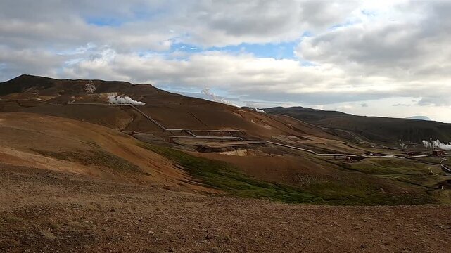 Krafla geothermal power plant with steam pipes in volcanic landscape, Iceland