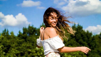Obraz premium Woman twirling in off shoulder top in grassy area