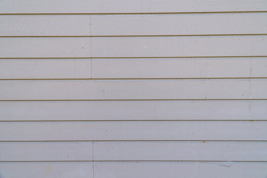 Clean white horizontal lined wall texture with subtle grooves, ideal for minimal background, modern design, and structured pattern concept.