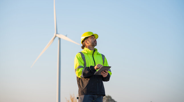 Engineer wearing uniform inspection and survey work in wind turbine farms.
