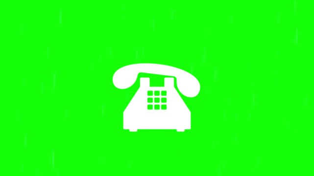 A white rotary telephone sits on a green and white background surface.