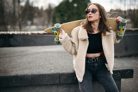 Stylish Woman with Skateboard Outdoors