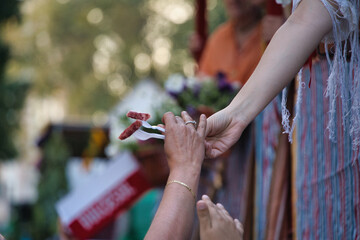 Fototapeta premium Giving away sausages with a fork at the parties