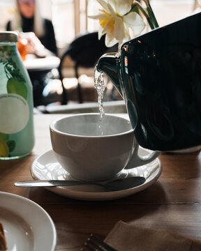 boiling tea pouring from a teapot in a cafe in England