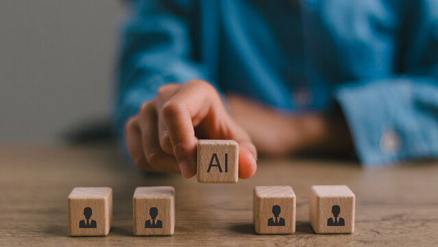 Artificial intelligence transforming human resources. Placing AI wooden blocks among human icons. AI transforming human resources, recruitment automation, workforce transformation, the future of work.