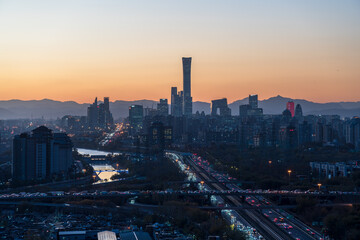 Naklejka premium Prosperous urban buildings in Beijing, China at dusk with sunset glow