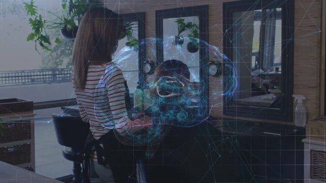 Stylist starting haircut, combing and trimming client hair while AR brain overlay guiding choices