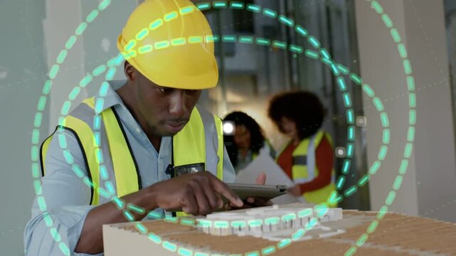 Site engineer tapping tablet, generating AR rings orbiting scale model for construction planning