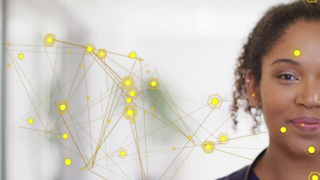 Woman clinician standing with stethoscope right, yellow nodes moving placing hexes on face smiling