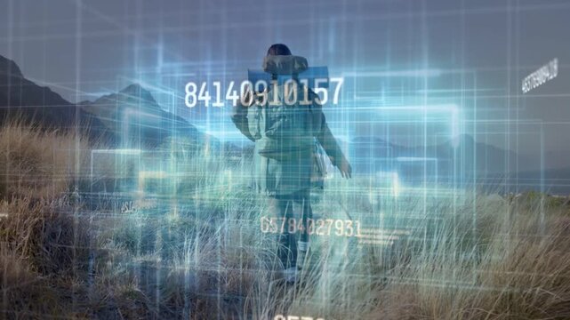 Woman hiking toward coast, walking causing blue hologram forming 3D boxes around her mapping route