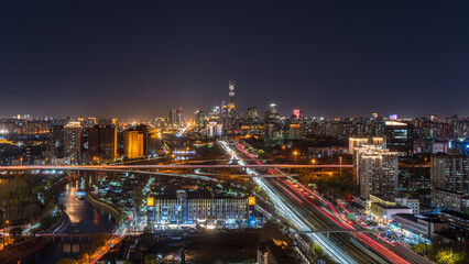Obraz premium Beijing city night skyline with traffic light trails along the Tonghui River, China