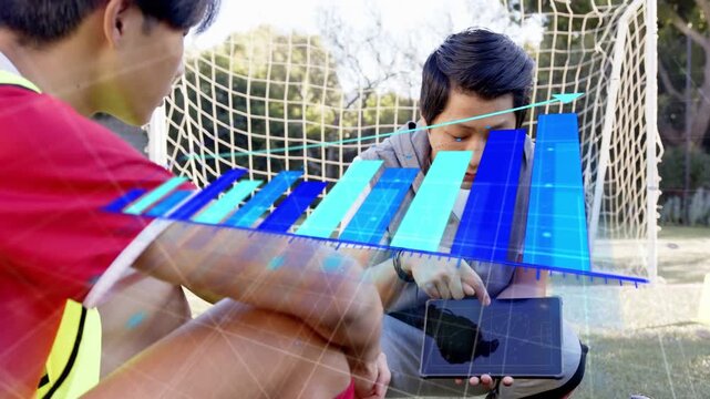 Coach kneeling pointing tablet by goal activating animated bars rising and coaching sports player
