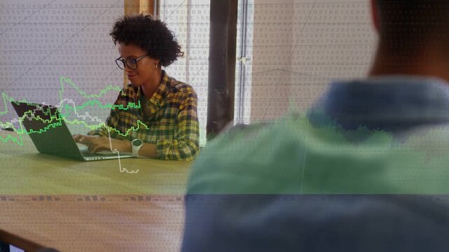 Woman typing on laptop, causing green white line graphs expanding across table for business insight