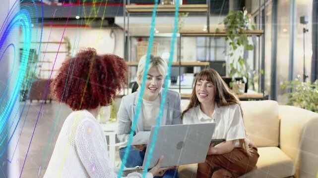 Vertical video: Neon sweeping clearing view showing 3 women using laptop and tablet reviewing biz