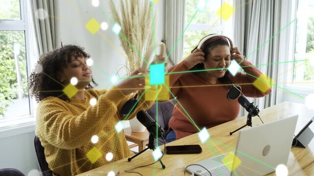 Two women cohosts testing audio in studio, tapping mics and causing network overlay for podcasting