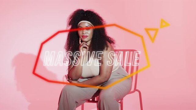 Model posing on chair neon polygon and MASSIVE SALE sliding from left tracking torso promoting sale