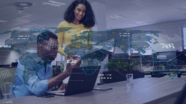Woman showing folder to colleague checking business data on laptop and phone, map overlay growing