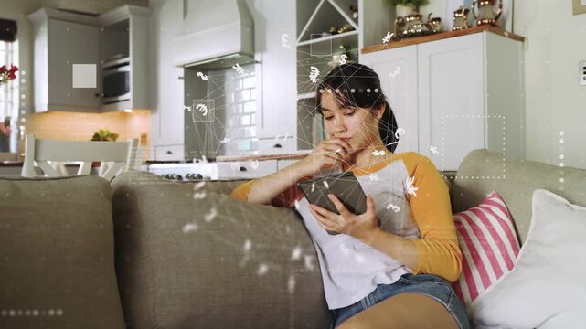 Vertical video: Tapping woman viewing tablet, swiping, reading on couch in raglan shirt, copy space